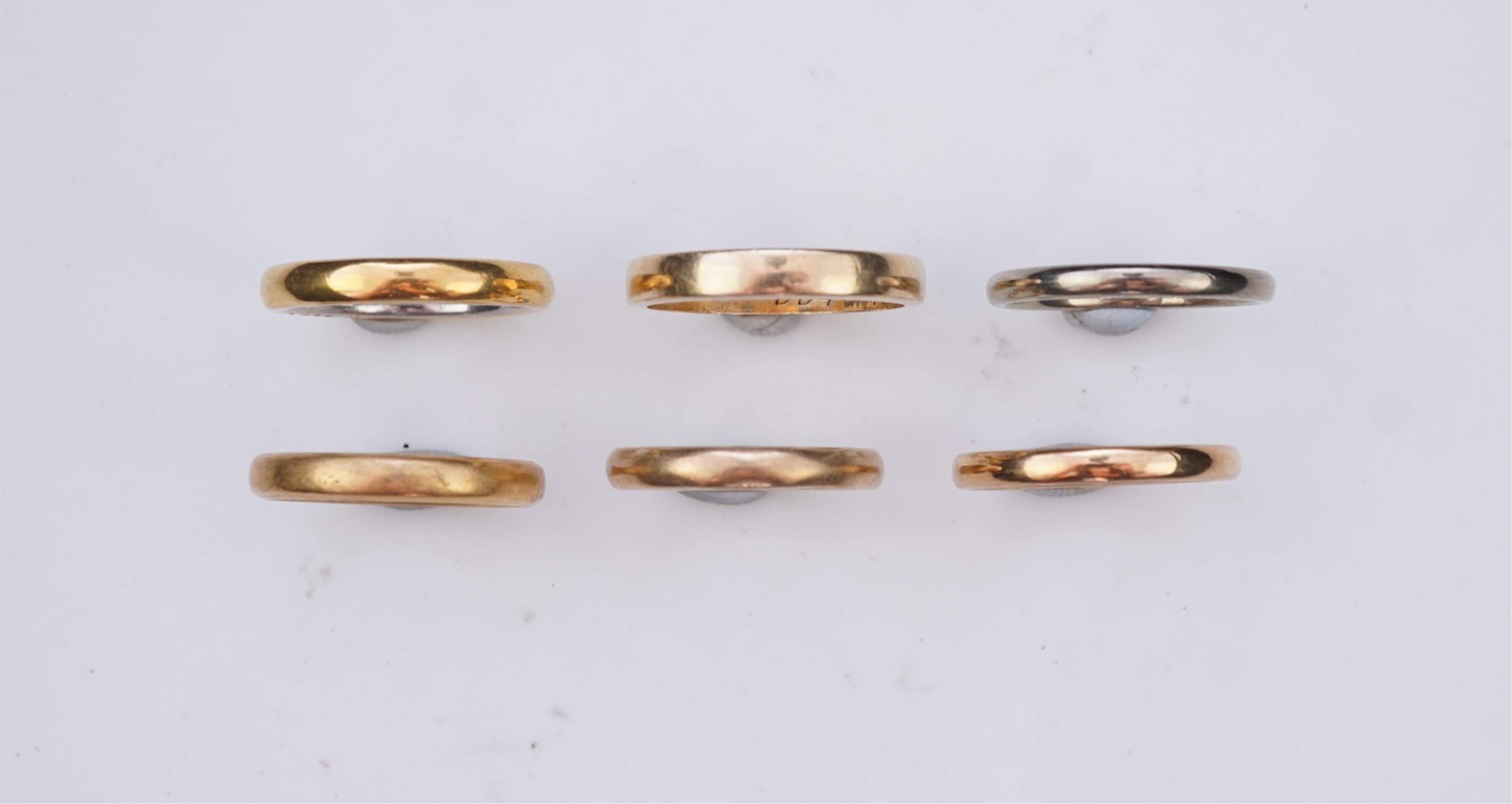 A collection of six gold wedding bands